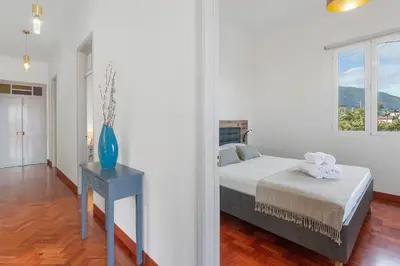 a bedroom with a bed and a vase on a table at Casa Da Avó Ferreirinha in Seixal
