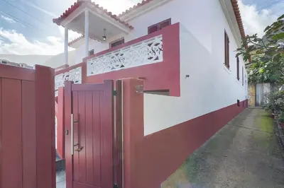 a red fence in front of a house at Casa Da Avó Ferreirinha in Seixal