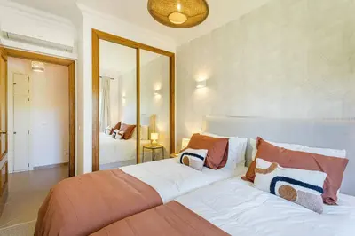 a bedroom with a large bed with pillows on it at Apartamento em Luxury Golf Resort in Lagos