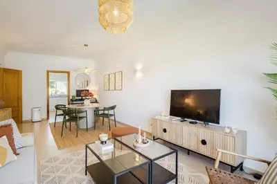 a living room with a large flat screen tv at Apartamento em Luxury Golf Resort in Lagos