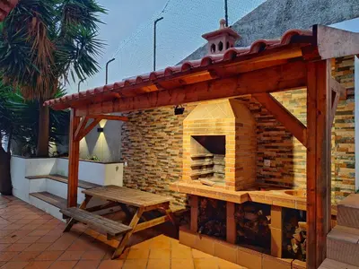 a patio with a table and chairs on a balcony at Skyline Home Funchal in Funchal