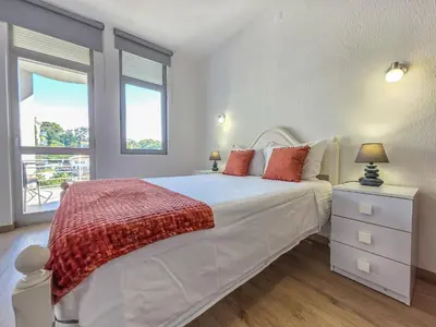 a bedroom with a white bed and a window at Blue Ship Residence in Funchal