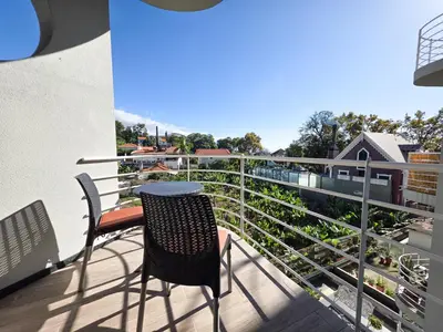 a balcony with a table and chairs on a balcony at Blue Ship Residence in Funchal