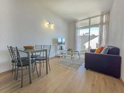 a living room with a table and chairs and a couch at Blue Ship Residence in Funchal