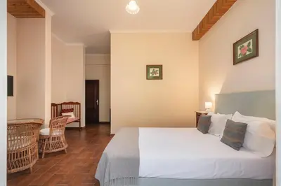 a bedroom with a large white bed in a room at Casa da Fajã Alta in São Jorge