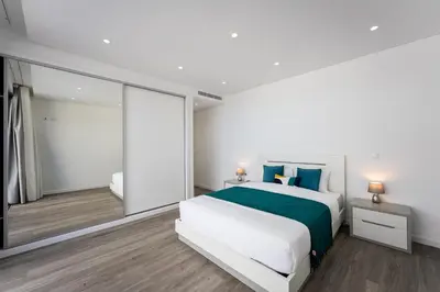 a bedroom with a large bed and a large window at Villa Matias - Private pool and family comfort in Arco da Calheta