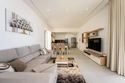 a living room with a couch and a table at Villa Matias - Private pool and family comfort in Arco da Calheta
