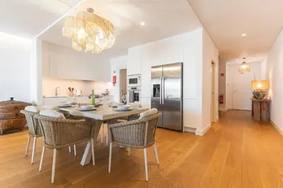 a kitchen and dining room with a table and chairs at Acqua Beach by Atlantic Holiday in Panasqueira