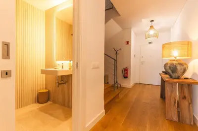 a hallway with a table and a vase on it at Acqua Beach by Atlantic Holiday in Panasqueira