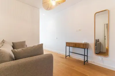 a living room with a couch and a mirror at Acqua Beach by Atlantic Holiday in Panasqueira