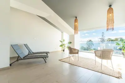 a living room with chairs and a large window at Acqua Beach by Atlantic Holiday in Panasqueira