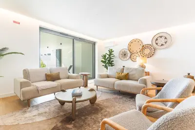 a living room with two couches and a table at Acqua Beach by Atlantic Holiday in Panasqueira