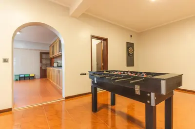 a pool table in a living room with an archway at Villa Alves by Altlantic Holiday in Faial