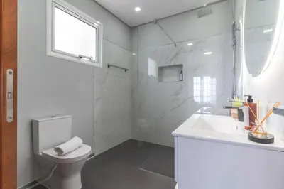 a white bathroom with a toilet and a sink at Villa Alves by Altlantic Holiday in Faial