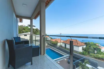 a balcony with a view of the ocean at Villa Alves by Altlantic Holiday in Faial