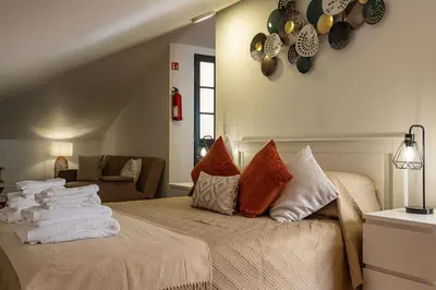 a bedroom with a bed with towels on it at Horizonte Azul in Ponta do Sol