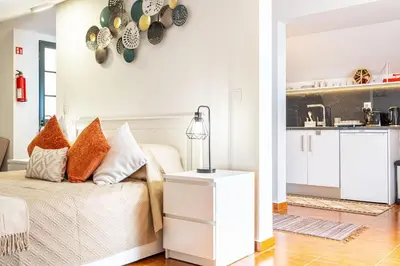 a white living room with a couch with pillows at Horizonte Azul in Ponta do Sol