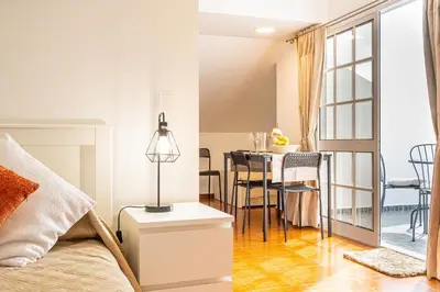 a bedroom with a bed and a dining room with a table at Horizonte Azul in Ponta do Sol