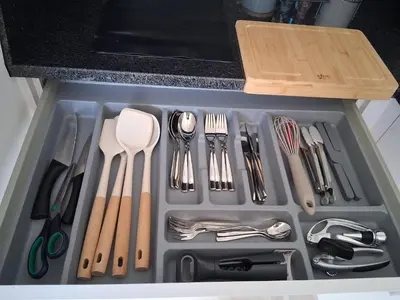 a drawer filled with utensils in a kitchen at Horizonte Azul in Ponta do Sol