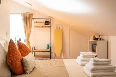 a room with a pile of towels and a surfboard at Horizonte Azul in Ponta do Sol