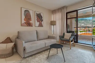 a living room with a couch and a chair at Upgrade Paradise Marina in Funchal