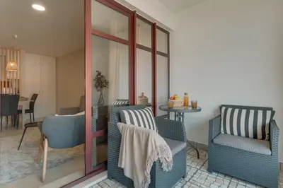 a living room with two chairs and a table at Upgrade Paradise Marina in Funchal