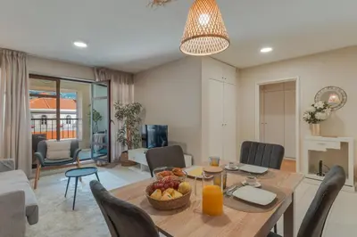 a dining room and living room with a table and chairs at Upgrade Paradise Marina in Funchal