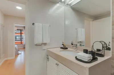 a white bathroom with a sink and a mirror at Upgrade Paradise Marina in Funchal