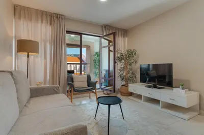 a living room with a couch and a tv at Upgrade Paradise Marina in Funchal