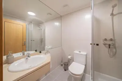 a bathroom with a sink and a toilet and a shower at Lido Ocean View - Perto da Praia com Estacionamento Privado in Funchal