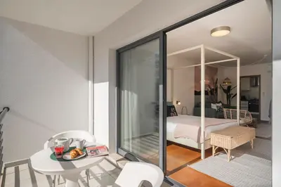 a room with a table and a bed in a room at Lido Ocean View - Perto da Praia com Estacionamento Privado in Funchal