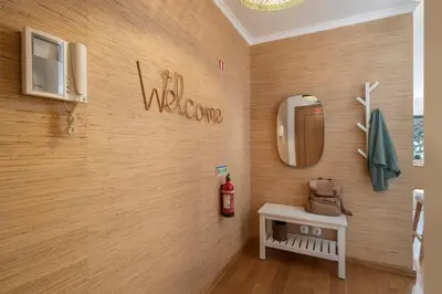 a room with a wall with a mirror and a table at Lido Ocean View - Perto da Praia com Estacionamento Privado in Funchal