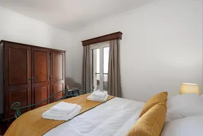 a bedroom with a bed with two towels on it at Villa Mirage - by Madeira To Stay in Arco da Calheta