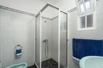 a bathroom with a shower and a toilet and a sink at Villa Mirage - by Madeira To Stay in Arco da Calheta