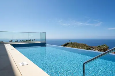 a swimming pool with a view of the ocean at OurMadeira - GrandView Cristo Rei in Caniço