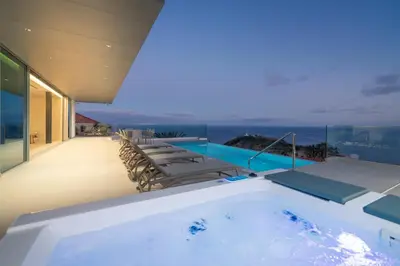 a hot tub on the balcony of a house at OurMadeira - GrandView Cristo Rei in Caniço