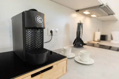 a coffee machine sitting on a counter with two cups at Casa Serafina by Rent-a-key in Santa Maria Madalena