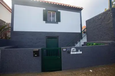 a small house with a green door and a window at Casa Serafina by Rent-a-key in Santa Maria Madalena