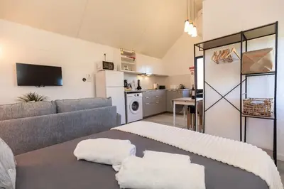 a living room with a couch and a kitchen at Casa Serafina by Rent-a-key in Santa Maria Madalena