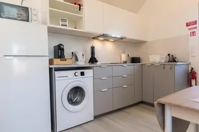 a kitchen with a washer and a washing machine at Casa Serafina by Rent-a-key in Santa Maria Madalena