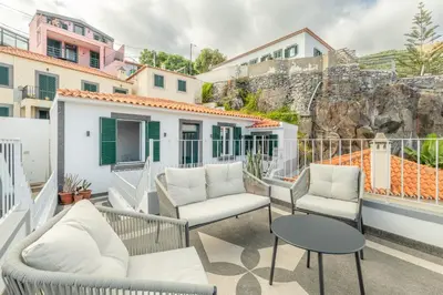 a balcony with two chairs and a table at Bay View Traditional house in city center in Câmara de Lobos