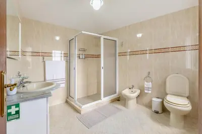 a bathroom with a shower and a toilet and a sink at Bay View Traditional house in city center in Câmara de Lobos