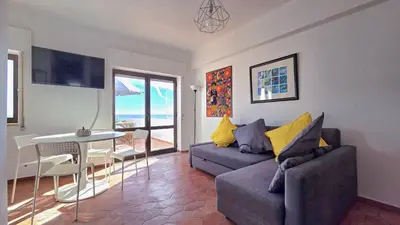 a living room with a couch and a table at Margarida Seaview Terrace Apartment in Luz
