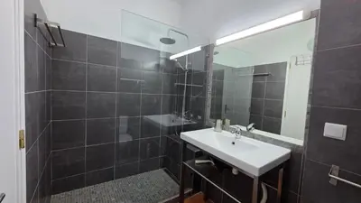 a bathroom with a sink and a mirror at Margarida Seaview Terrace Apartment in Luz