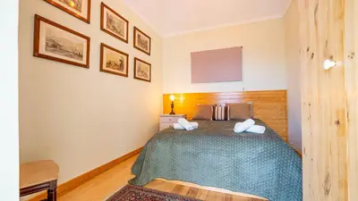 a bedroom with a bed and a tv on the wall at The Goat's Place III in Gaula