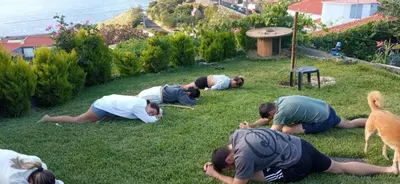 a group of people laying in the grass at The Goat's Place III in Gaula