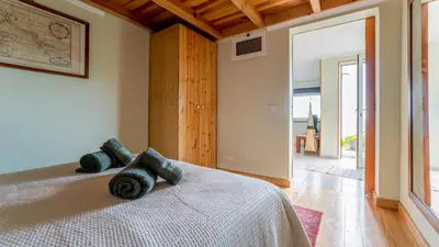 a bedroom with a bed and a large window at The Goat's Place III in Gaula