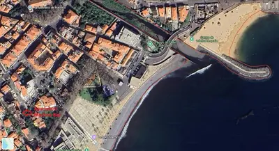 an overhead view of a city and the water at Machico Bay in Machico