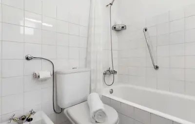 a bathroom with a shower and a toilet and a sink at Machico Bay in Machico
