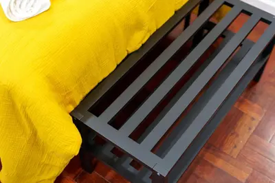 a bed with a yellow blanket on top of it at Carmo Downtown Apartment by Amazing Madeira in Funchal